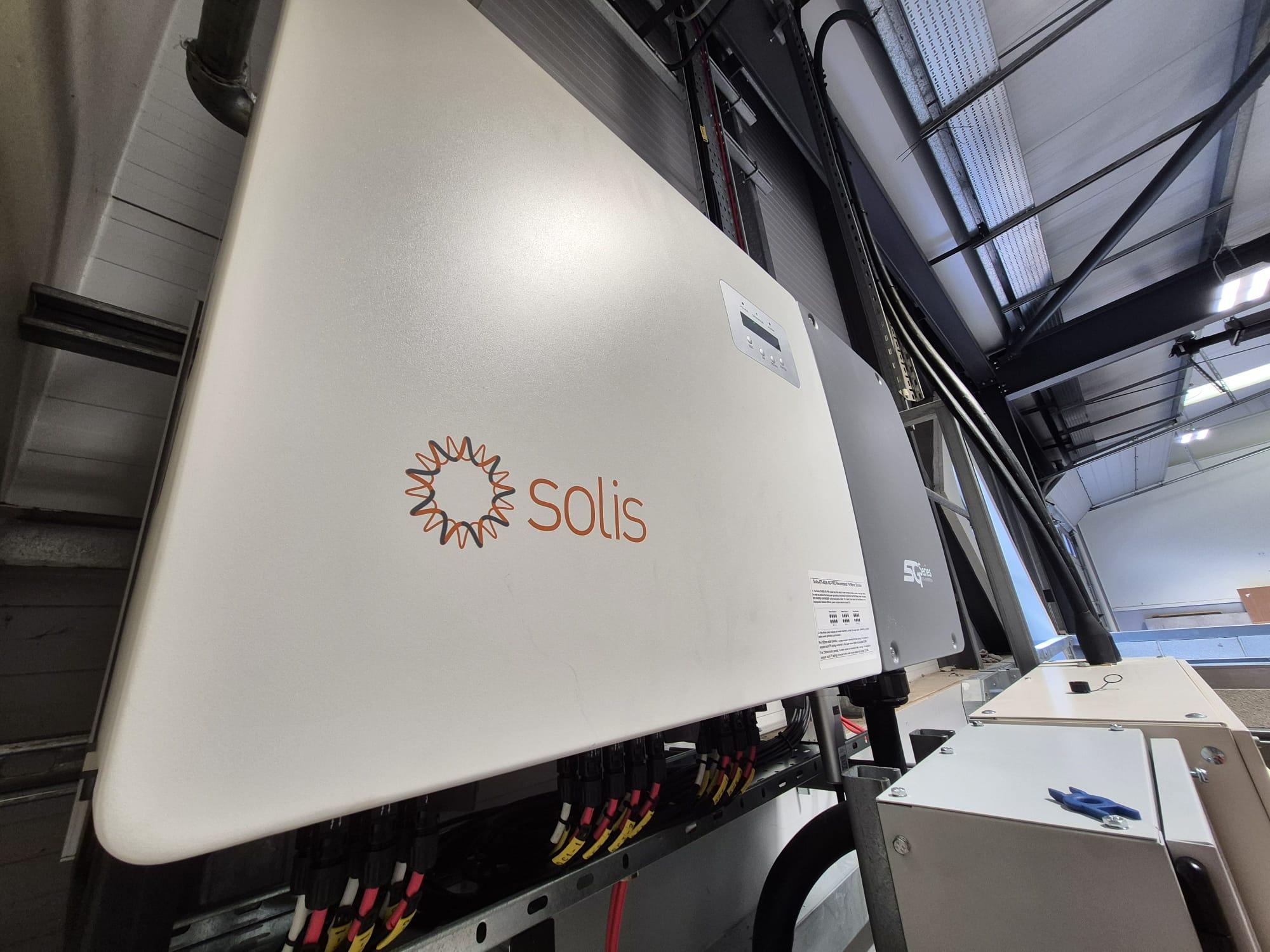 Solis inverter mounted in a commercial building with DC cabling connected underneath.