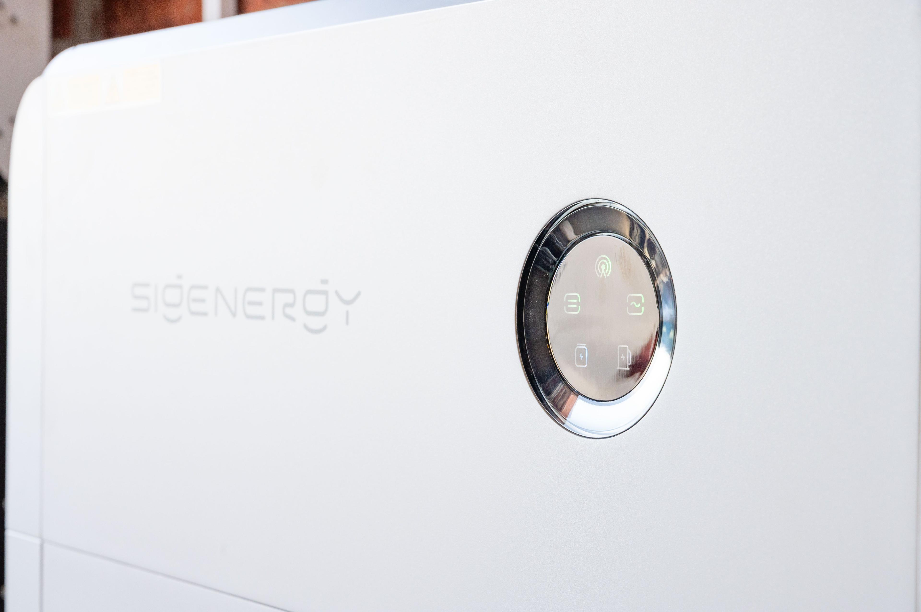 Close-up of the illuminated control panel on a white Sigenergy battery unit.